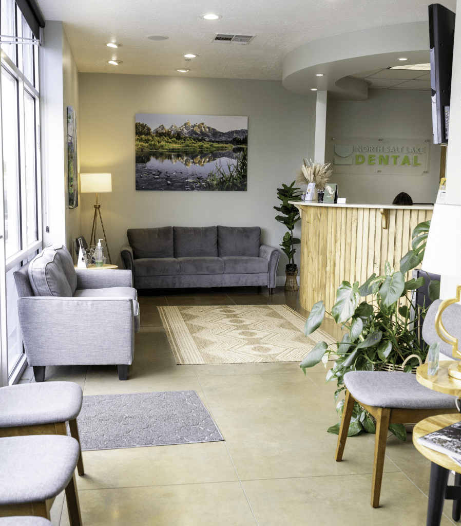 Modern dental office waiting room with comfortable seating and contemporary décor.
